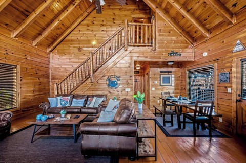 Large living area under cathedral ceiling adjacent to dining and kitchen