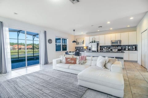 Bright and open living space with plush seating and lake views.