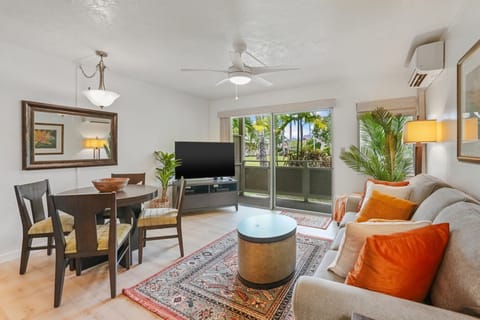 Lounge in comfort on the queen-size sleeper sofa, with central A/C, a flat-screen TV, and sliding doors leading to your private lanai surrounded by tropical greenery.