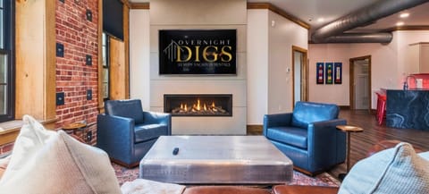 Exposed brick, a gas fireplace, and floor-to-ceiling windows — one flight above Deluca's Pizza on Central Avenue