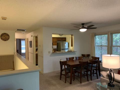 Bright dining area with open kitchen design — perfect for shared meals and conversation.