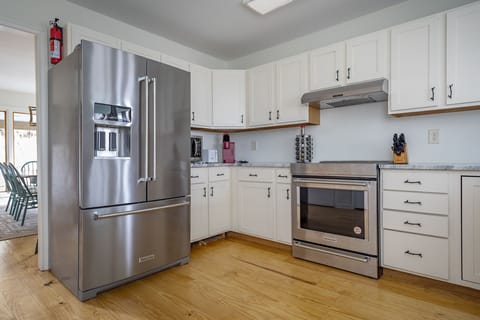 Kitchen with stainless appliances, dishwasher & Keurig coffeemaker.