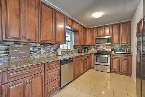 Modern, stainless steel appliances including a stove, oven, microwave, and dishwasher are included in the spacious kitchen.