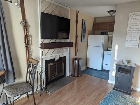 Living room with Smart TV and wood burning fireplace