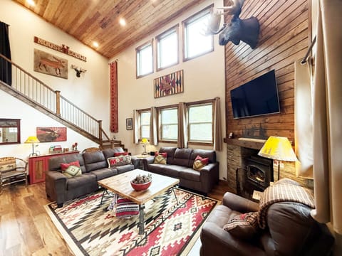 Gather, unwind and reconnect in this spacious great room, featuring soaring lodge-style design, comfortable seating, a cozy fireplace and Smart TV for memorable evenings together.