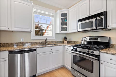 Stainless steel appliances and white cabinetry create a bright and inviting space.