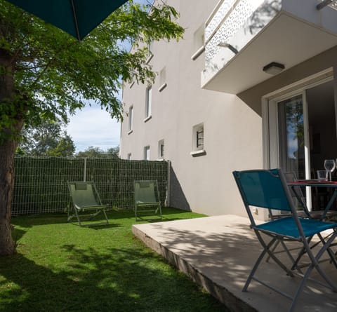 Shady, fenced garden with electric grill.