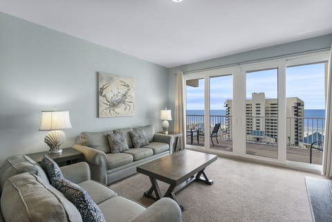 Relax in this coastal living room with ocean views through large glass doors.
