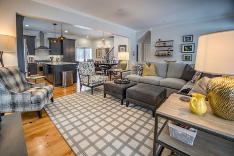 The open-plan living space features a cozy living room adorned with a gas fireplace, perfect for guests to unwind and relax.