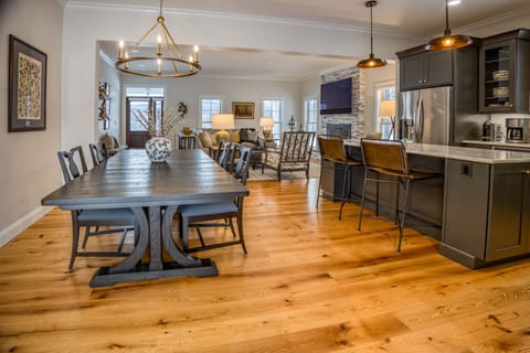 The kitchen is a chef's dream, outfitted with a Nespresso machine, fondue pot, Dutch oven, cocktail bar cart, outdoor grill, and pizza oven. 