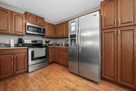 Kitchen: Create culinary masterpieces in this inviting space with modern appliances and warm wood accents!