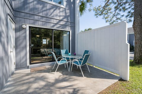 Patio Retreat: Savor morning coffee in the sun with stylish seating and vibrant decor!