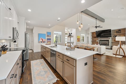 Expansive kitchen features a large island, ideal for gathering and culinary adventures during your stay.