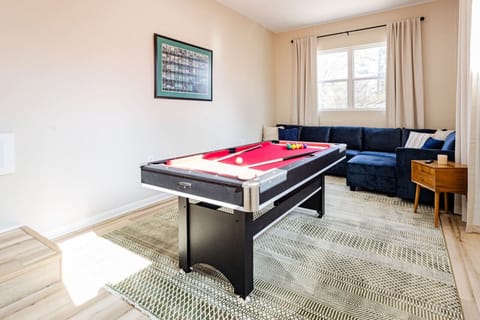 Game On: Our Multi-Functional Gameroom Features a Pool Table that Doubles as Ping Pong, Alongside a Modular Sectional Sofa for Ultimate Lounging - Where Entertainment Meets Comfort! 🎱🏓🛋️