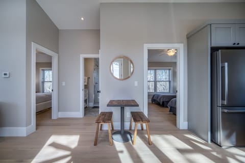 Cozy Indoor Table and Bedrooms Off Living Area