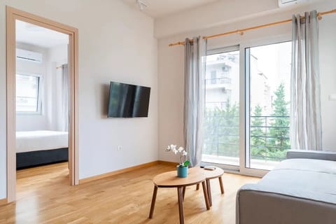 Deluxe Apartment | Living area | 42-inch LED TV with cable channels