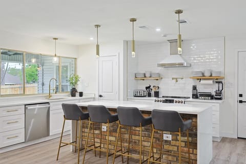 Beautifully upgraded with stainless steel appliances, open shelving, and a kitchen island, this fully equipped kitchen has everything you need for all your cooking needs and more!