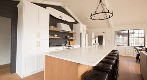 Kitchen has cafe appliances with double oven and large island with seating for 8