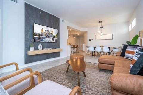 Step into this spacious, comfortable living area. The expansive room is adorned with tasteful decor, offering a blend of modern aesthetics and homey warmth. 