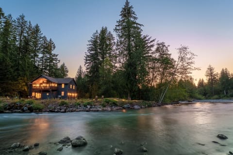 Stand at the water's edge at dusk and watch the lights come on behind you.