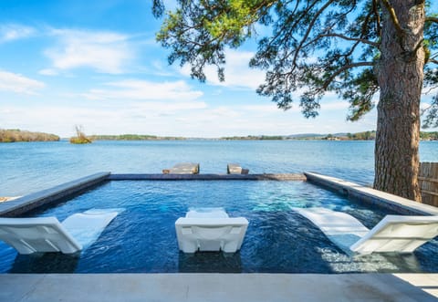 Overlooking the lake, the infinity-edge pool creates a peaceful place to cool off while enjoying the scenery.