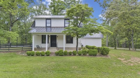 Two-story farmhouse with wide front porch