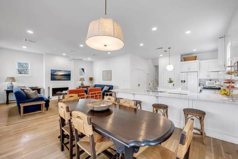 Indoor dining space has seating for 6 and extra barstools around the kitchen