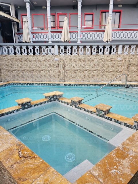 Outdoor pool, open 8:00 AM to 10:00 AM, pool umbrellas