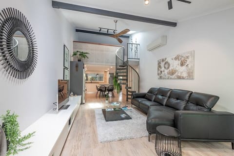 Single level openness & sleek kitchen leading to bedroom wing and garage.