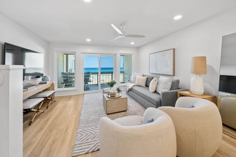 Unwind in your bright living room with stunning ocean views through floor-to-ceiling windows and a private balcony.