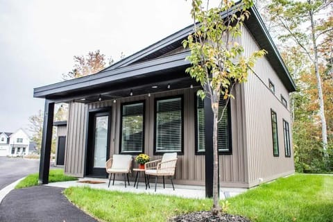 This is the front of the tiny home with two seats to sit out on and enjoy the peaceful neighborhood. There are stringed lights that light up at night as well!