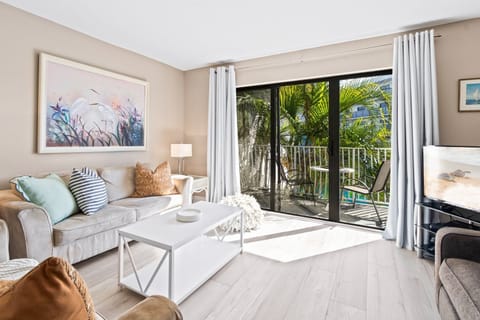 Bright & airy living room with sliding glass doors that lead to private balcony