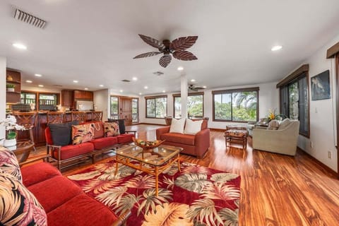 Relax in a spacious lounge filled with natural light and tropical-inspired accents