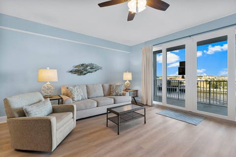 Living Area with Lake and Light Show Views, Flat Screen TV, Sleeper Sofa, and Private Balcony