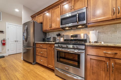 Gorgeous fully stocked kitchen with oversized island, full sized appliances and seating for 5 at the bar.
