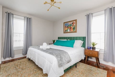 Experience royalty in the `Green King`s` primary bedroom, featuring a luxurious king bed and a flat-screen TV equipped with Roku for endless entertainment.