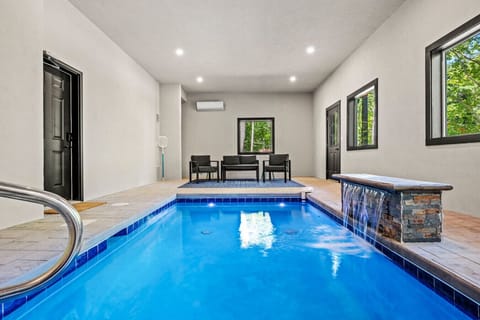 The indoor pool is located on the lowest level of the cabin. The hot tub is located on the deck just outside the door.