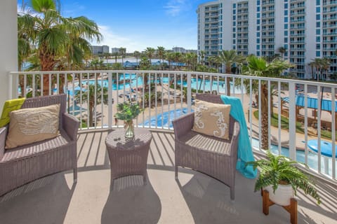 Your private balcony offers stunning views of the sparkling pool area and tropical palms below, where you can sip morning coffee in comfort.