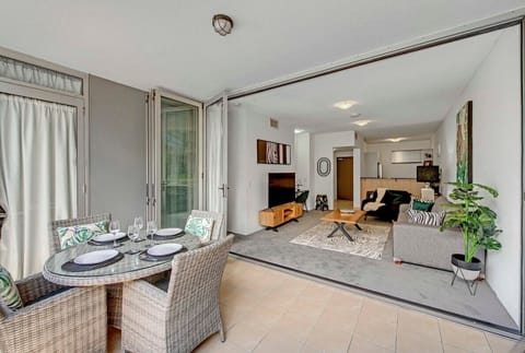 Balcony dining with city views and seamless indoor-outdoor flow.