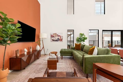 Step into our vibrant bohemian-inspired living space, complete with soaring ceilings that add an extra touch of grandeur to your stay