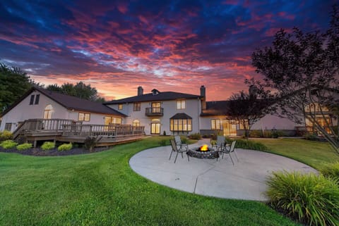 Enjoy the view of the house with a picturesque sky and inviting fire pit.