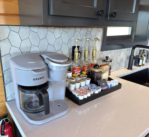 Coffee bar includes a Keurig drip/k-cup combo machine + flavor syrups, sugar, creamer, etc