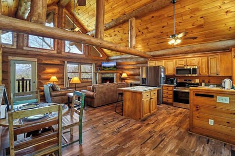 The main level living area with bold logs and beams highlighting the cabin's authenticity. 
