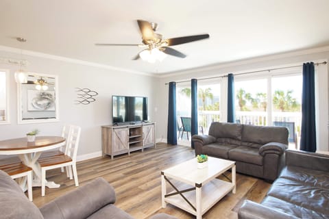 Relax in your bright, open living space with comfortable seating and tropical views from your private balcony.