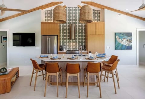The fully equipped kitchen features modern appliances, sleek countertops, and ample cabinet space, making meal preparation a breeze.