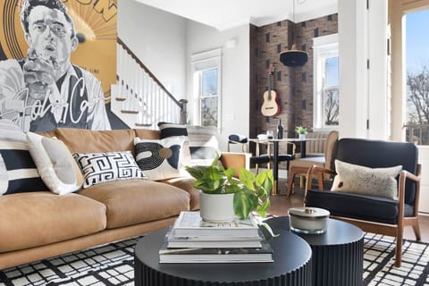 Living room goals - cozy couch, lounge chairs, and #Johnnycash in sight