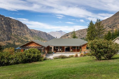 Exterior Retreat: Stunning mountain views enhance this inviting wooden lodge, perfect for adventure seekers!