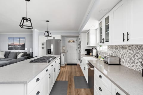 Kitchen leads you into the game room or out back to the fenced pool area