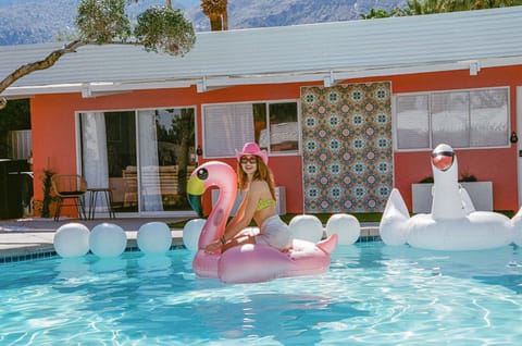 Paradise found! 🌴 Our vibrant heated pool is designed for maximum fun and relaxation. Grab a floatie and enjoy the good life in Palm Springs.