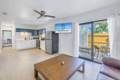 Spacious open-plan living room with smart TV and full kitchen at The Coral Cabanas, Siesta Key 2BR.